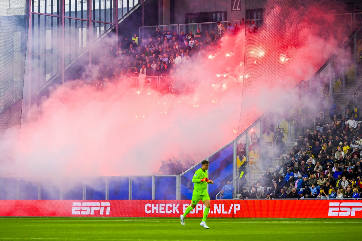 Dutch football shame as fireworks thrown by Feyenoord fans injure rival supporters