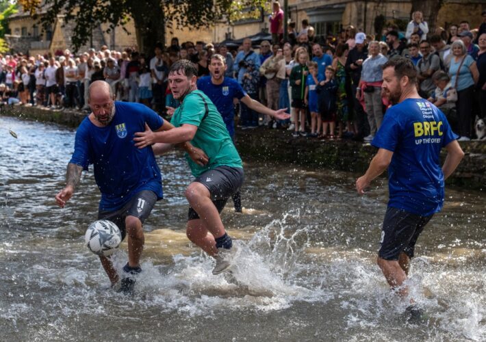 Hundreds flock to the Cotswolds to watch bizarre football match in river